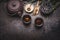 Traditional Asian green tea setting with teapot, cups, candle and honey on dark rustic background with copy space, top view