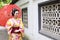 Traditional Asian Japanese beautiful Geisha bride woman wears kimono hold a umbrella in a summer nature garden