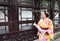 Traditional Asian Japanese woman bride Geisha wearing kimono play in a graden hold an umbrella stand by a boat
