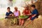 Traditional Asian Thai rural daily life, grandchildren in cultural costumes help their seniors preparing local food ingredients