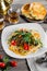 Traditional asian uzbek noodle lagman with vegetables and meat on rustic wooden table background