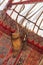 Traditional Asian wooden bow with arrows hanging on the felt wall of a yurt