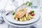 Traditional Atlantic fried salmon filet white asparagus in sauce hollandaise and tomatoes on a classic design p