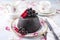 Traditional Australian plum pudding with fresh forest berries on a design dessert plate