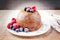 Traditional Australian plum pudding with fruits on a dessert plate