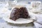 Traditional Australian plum pudding with vanilla rum sauce on a design plate