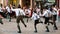 Traditional Austrian folkloric dancing performing on streets with traditional clothes garments lederhosen and dirndls.
