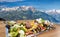 Traditional austrian food experience over Zell am see village with Kitzsteinhorn peak  Tauern Alps in Austria
