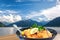 Traditional austrian food Wiener schnitzel against Zell am see village with lake in Austria