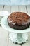 Traditional Austrian Sacher chocolate cake with crumbles on an ceramic cake plate