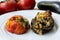 Traditional azerbaijani eggplant dolma also called three sisters made vegan: an aubergine and a tomato stuffed with spicy rice and