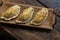 Traditional baked Argentine and Uruguay empanadas savoury pastries with meat beef stuffing against wooden background