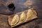 Traditional baked Argentine and Uruguay empanadas savoury pastries with meat beef stuffing against wooden background