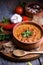 Traditional baked beans in tomato sauce cooked in retro clay pot with spices and vegetables