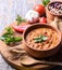 Traditional baked beans in tomato sauce cooked in retro clay pot with spices and vegetables