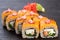 .traditional baked Japanese sushi with salmon avocado and soft cheese garnished with sauce. Japanese kitchen. Japanese