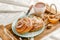 Traditional bakery or kanelbulle with walnuts on wooden tray. Breakfast or snack concept. Close up