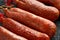 Traditional Balearic raw cured meat sobrassada sausage made from ground pork, paprika and spices on rustic black