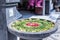 Traditional Bali offering with petals, flowers and leaves on display in a stone bowl in Bali, Indonesia, Asia