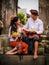 Traditional Balinese ceremony. Multicultural couple making Hindu religious ceremony with offerings. Caucasian wife and Balinese