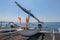 Traditional Balinese fisherman fishing boats on a beach with black volcanic sand. Sunny day with blue sky in tropical paradise. Fi