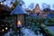 Traditional Balinese lantern glowing at dusk with a lake and temple in the background