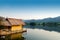 Traditional bamboo raft houses on the lagoon with mountain background at khao wong reservoir Suphanburi province Thailand