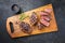 Traditional barbecue dry aged sliced wagyu sirloin beef steak with spice and herbs on modern design wooden design boa