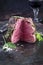 Traditional barbecue dry aged wagyu chateaubriand beef steak offerd spice and herbs on a rustic metal board