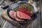 Traditional barbecue dry aged wagyu point steak sliced in a rustic cast iron pan