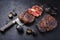 Traditional barbecue dry aged wagyu rib-eye beef steaks with charred onion sliced on a rustic large knife