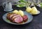 Traditional barbecue gourmet duck breast filet with skin with potato dumplings in dark beer sauce on a design plate