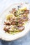 Traditional barbecue Greek calamari with herb and lemon slice on a design plate