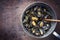 Traditional barbecue Italian blue mussel with rosemary in a rustic casserole