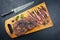 Traditional barbecue wagyu bavette steak with green chili and spices on a wooden design board