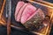 Traditional barbecue wagyu point steak roast sliced on a rustic wooden cutting board