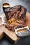 Traditional barbecue wagyu pulled beef with Louisiana sauce  on a rustic cutting board