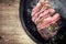 Traditional barbecue wagyu roast beef sliced on a rustic metal tray