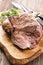 Traditional barbecued Greek lamb shoulder with with herb aund spice on a wooden design board