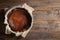 Traditional basque burnt cheesecake in the baking mold on wooden table