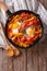 Traditional Basque piperade with eggs close-up. vertical top vie