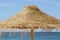 Traditional bast parasols detail at the sandy Atlantic beach