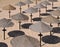 Traditional bast parasols at the sandy Atlantic beach