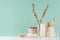 Traditional bathroom interior with beige accessories for bath - brush, comb, towel, bath sponge, glass vases on white wood table.