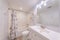 Traditional bathroom with white floral theme and tub shower with subway tiles surround