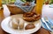 traditional Bavarian meal: white sausages, salty pretzels, sweet mustard, German beer and basket of prezels on Bavarian napkin