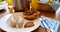 traditional Bavarian meal: white sausages, salty pretzels, sweet mustard, German beer and basket of prezels on Bavarian napkin