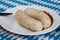 Traditional Bavarian sausages on a plate with sauce. Celebrating the traditional German beer festival called Oktoberfest