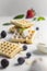 Traditional belgian waffles with fresh berries on grey background. Generative AI