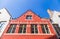 Traditional Belgium brick wall building in red and off-white col